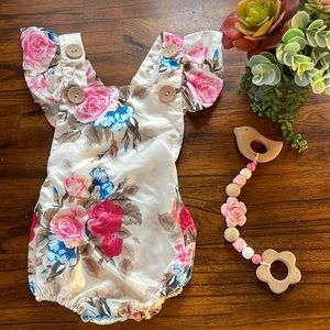 Baby girl floral romper with adjustable straps.